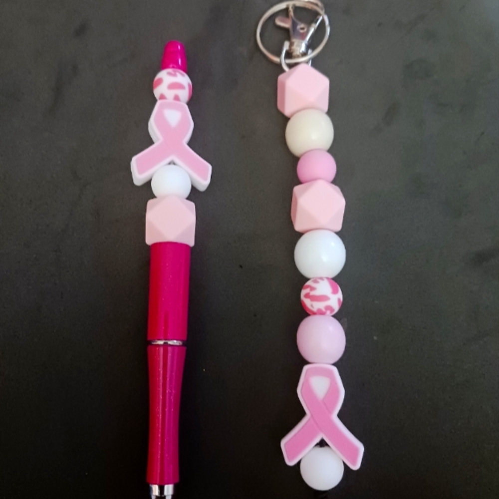 Pink and white Keychain and pen set with cancer surviver charm.